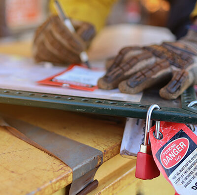 Construction worker inspects safety tags at a worksite