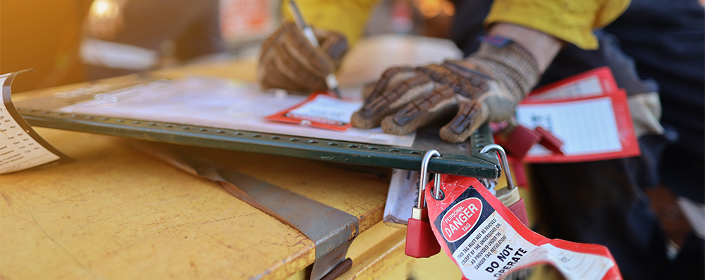 Construction worker inspects safety tags at a worksite